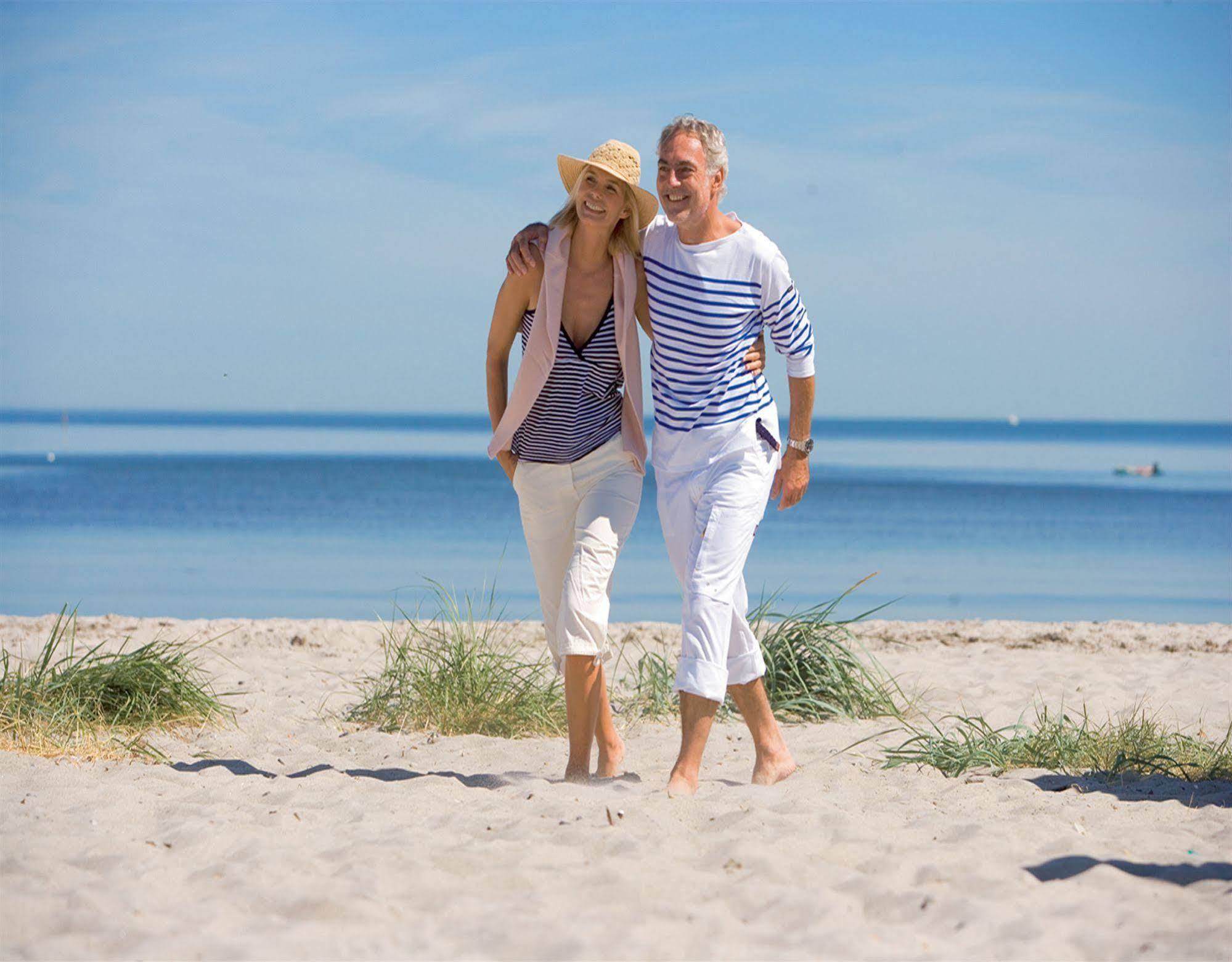 Yachthafenresidenz Hohe Duene Hotell Rostock Eksteriør bilde A couple walking on the beach